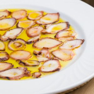 Getrockneter Oktopus mit Flamme und nativem Olivenöl extra